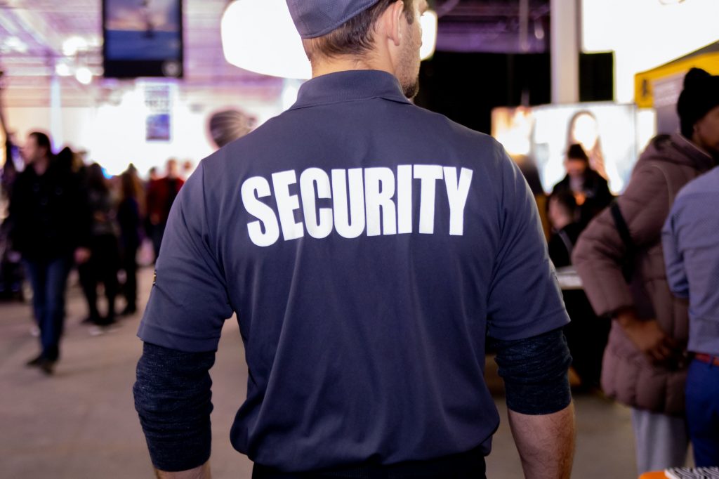 Closeup shot of a security guard in uniform patrolling in a commercial building